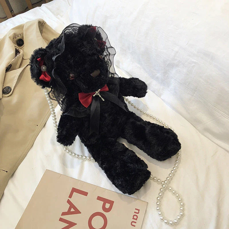 A plush teddy bear crossbody messenger bag with an adjustable shoulder strap and a zippered interior pocket for convenient storage.