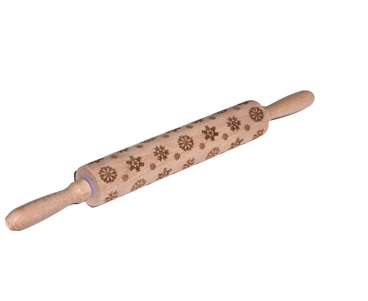 Wooden rolling pin with engraved Christmas patterns including reindeer and snowflakes on a 45cm long barrel.