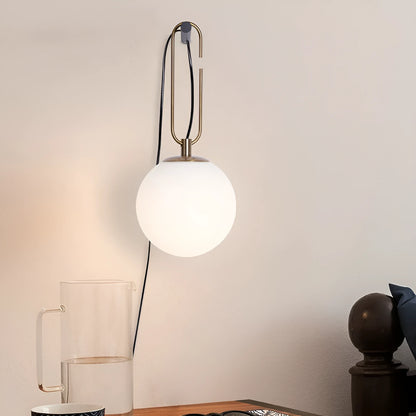 Modern glass wall lamp mounted on a wall, showcasing its clean design and adjustable light colour options.
