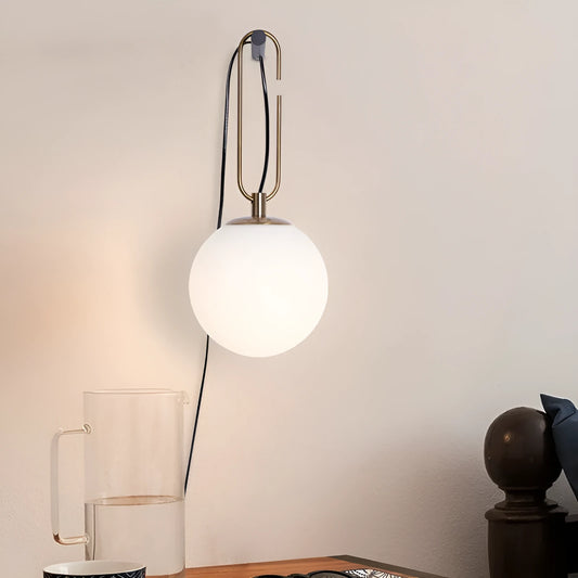 Modern glass wall lamp mounted on a wall, showcasing its clean design and adjustable light colour options.