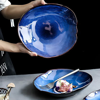 Blue irregular ceramic plate with kiln-changing glaze pattern, measuring approximately 20cm across irregular edges