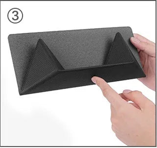 Blue or grey foldable laptop cooling stand with anti-slip surface on a desk.