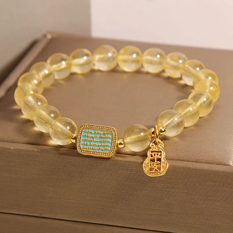 Women's bracelet crafted from natural yellow crystal featuring a citrine colour and rhinestone embellishment, designed as a versatile accessory for everyday wear or special occasions, supplied as a single piece in its packaging.