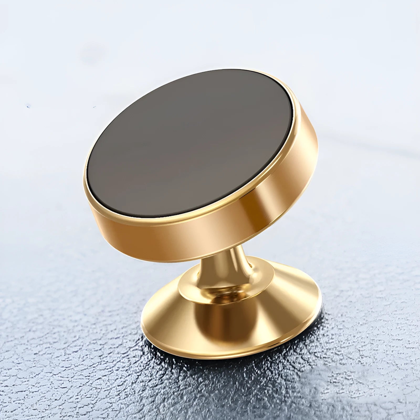 Silver magnetic car phone holder with flexible gooseneck attached to a car windscreen, holding a mobile phone.