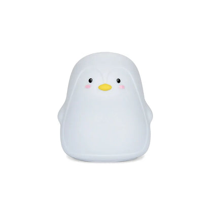 White silicone penguin-shaped USB rechargeable night light on a surface.