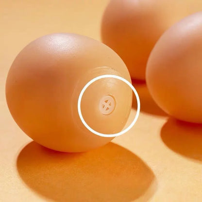 Pink rubber simulation egg dog toy with a textured surface for chewing.