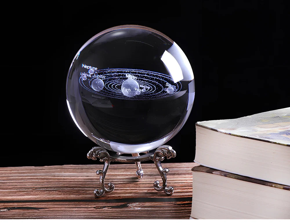 Solar system crystal ball showing planets inside K9 optical crystal sphere on metallic base
