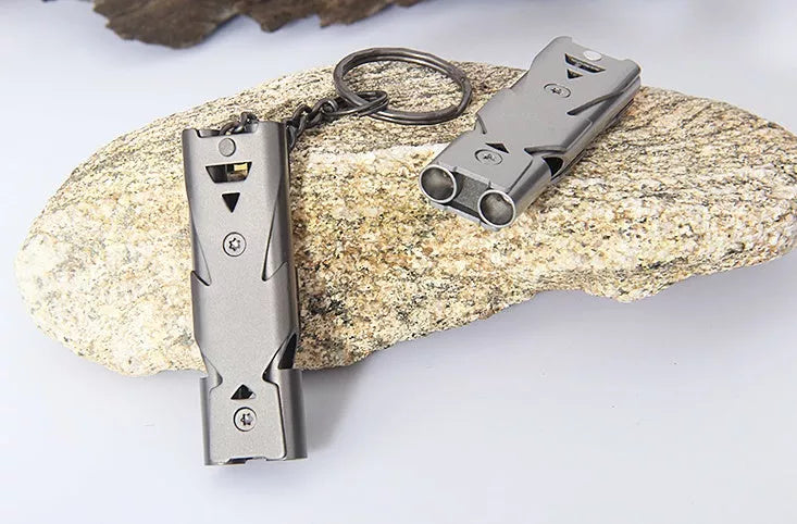 Durable metal keychain whistle in silver and black, compact design for safety
