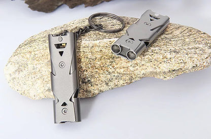 Durable metal keychain whistle in silver and black, compact design for safety