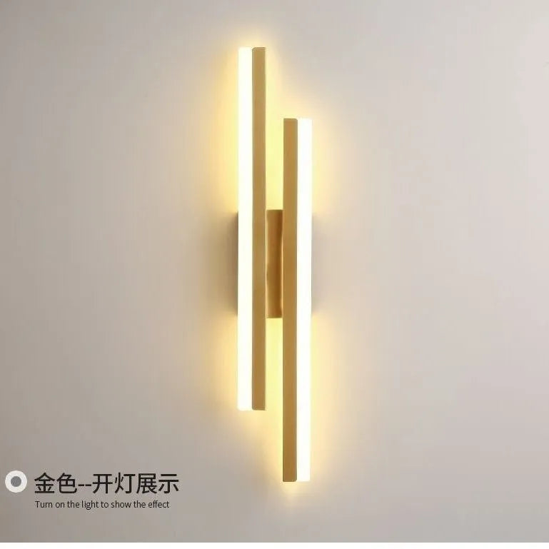 Scandinavian minimalist LED wall light with acrylic shade and adjustable arm in black or gold finish.