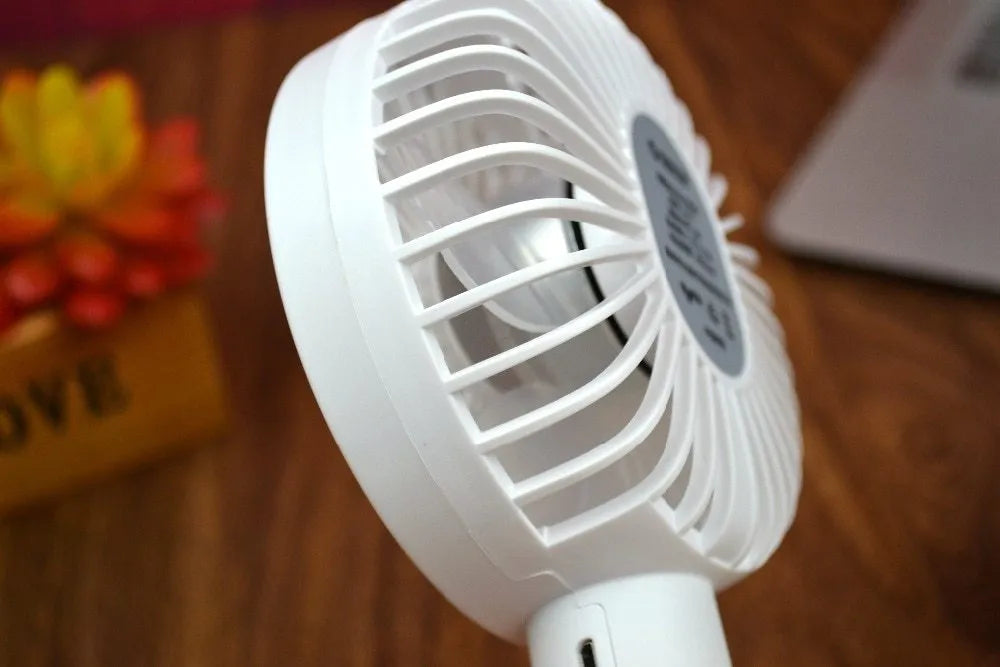 White ORICO FH1 portable USB desk fan with rechargeable battery on a wooden desk