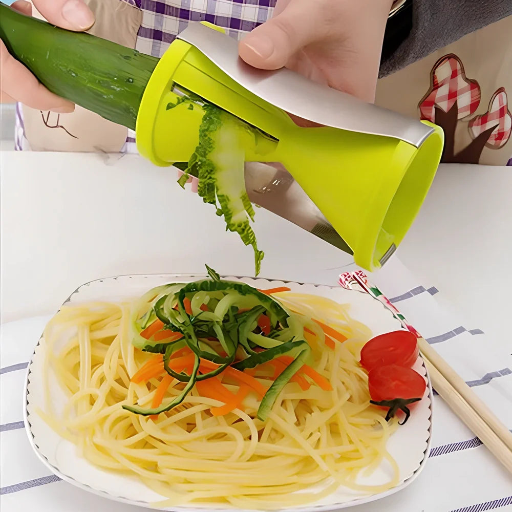 White spiral vegetable slicer with stainless steel blades on kitchen counter with zucchini noodles