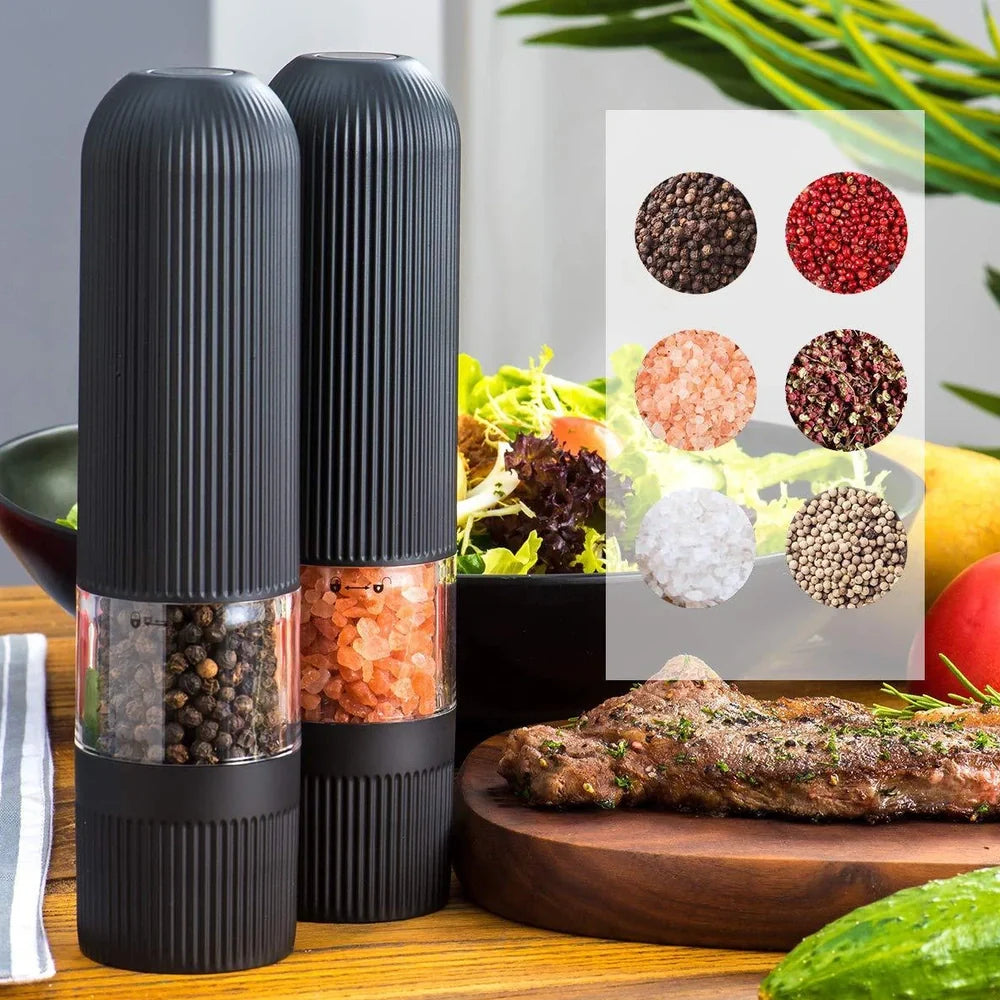 Black electric pepper grinder with transparent section showing peppercorns and ceramic grinding mechanism