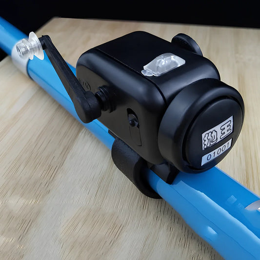 Black sea fishing bite alarm with ABS shell and polymer mounting belt for rod attachment