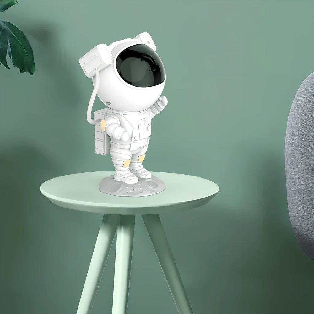 Astronaut-themed galaxy projector with adjustable nebula effects on table showing starry sky projection