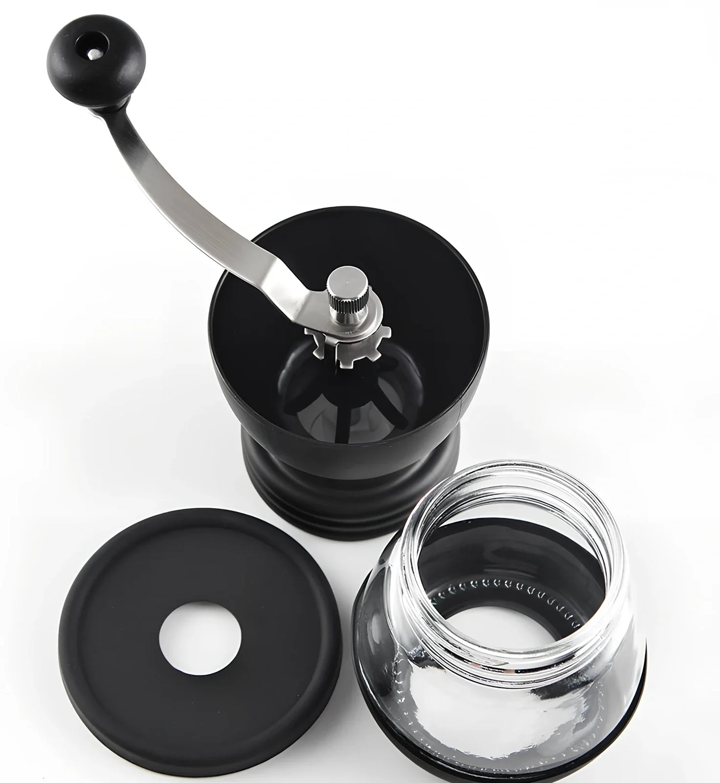 Manual coffee grinder with beech wood body and stainless steel grinding mechanism on kitchen counter
