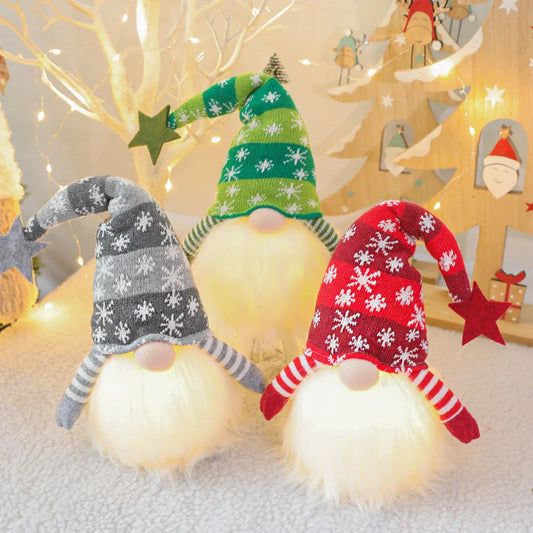 Festive faceless gnome dolls in various colors, including green, red, and grey, with battery-powered lights for cozy Christmas decor