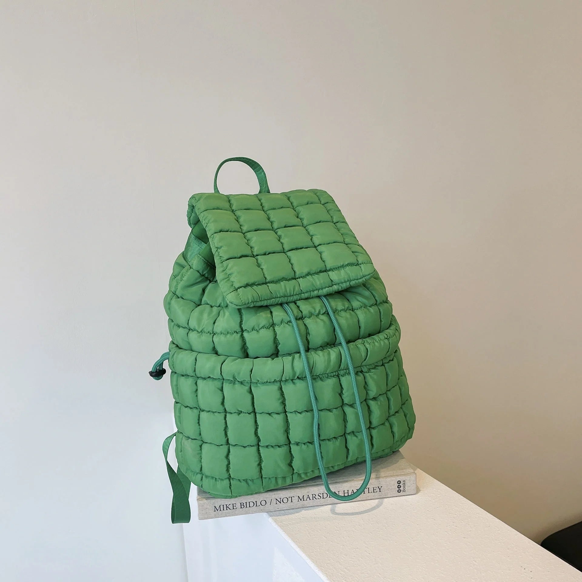 Soft, quilted puffer backpack in a variety of colors, perfect for autumn and winter wear
