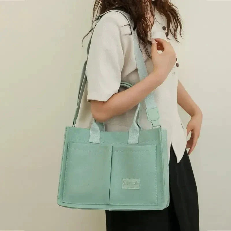 Premium canvas tote bag in multiple colors with adjustable shoulder strap and organizational pockets