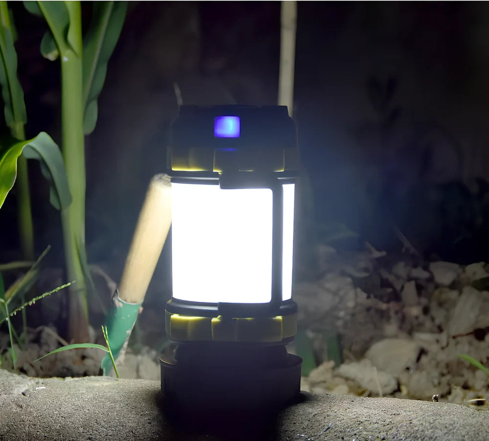 Green camping light with LED display showing multiple lighting modes and USB charging port