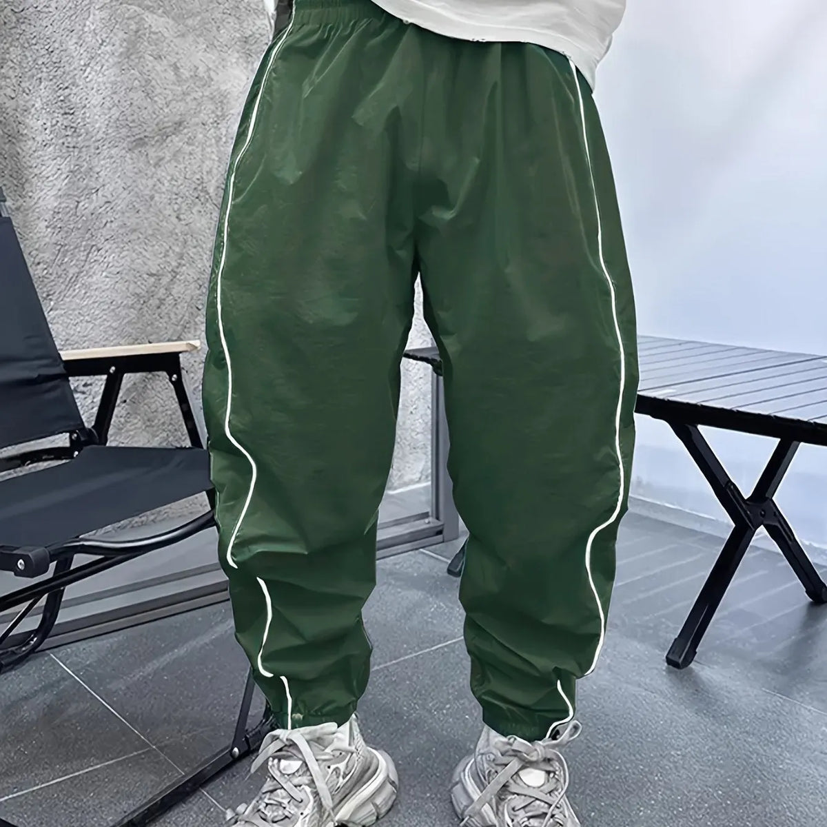 Men's bamboo fibre cropped sports trousers in army green colour showing loose fit and elastic waistband