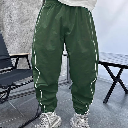 Men's bamboo fibre cropped sports trousers in army green colour showing loose fit and elastic waistband
