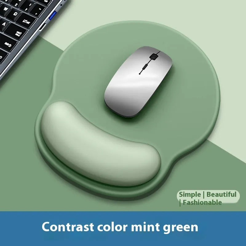 Silicone mouse mat with wristband in a gradient blue black colour pattern on a desk.