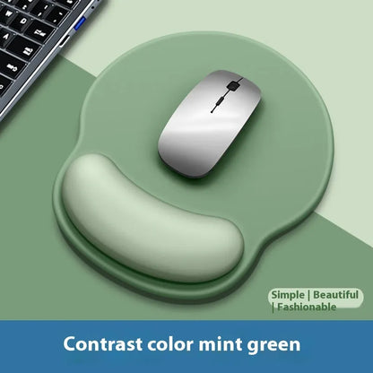 Silicone mouse mat with wristband in a gradient blue black colour pattern on a desk.