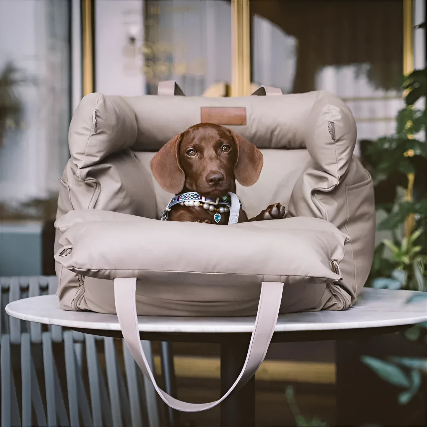 Green waterproof dog car nest with a removable cover, shown placed in a vehicle boot.