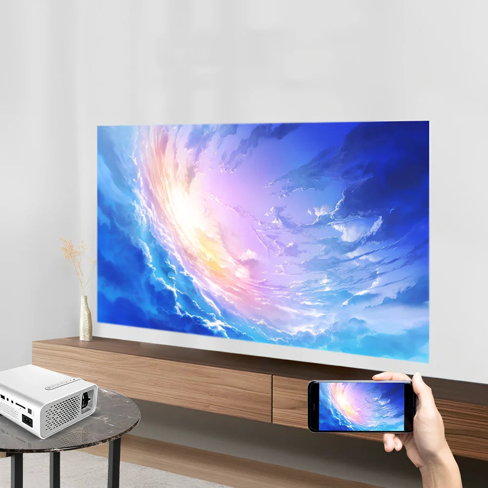 White portable home projector displaying 138-inch image with remote control and connectivity cables