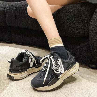 Women's black retro platform sports shoes with round toe and front lace-up fastening.