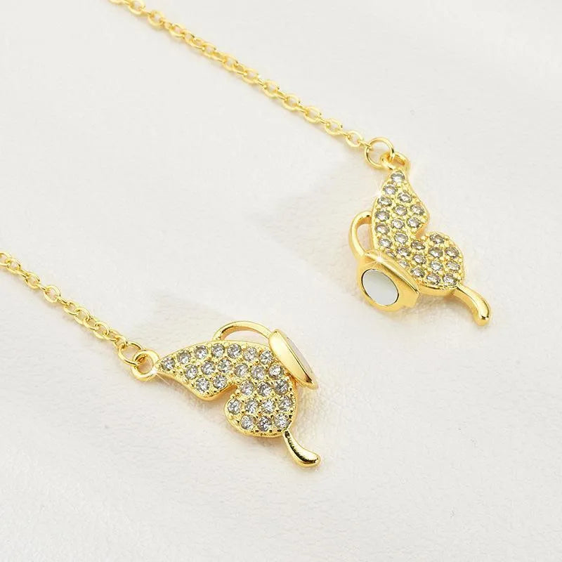 Gold titanium steel clavicle chain necklace with a magnetic butterfly pendant on a twisted chain.