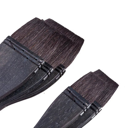 Grey squirrel hair makeup brush with a wooden handle on a plain background