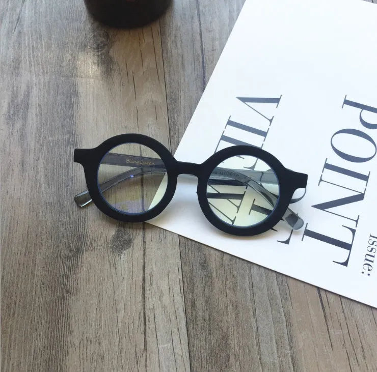Retro round frame anti blue light glasses in various colours on a plain background