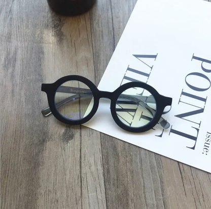 Retro round frame anti blue light glasses in various colours on a plain background