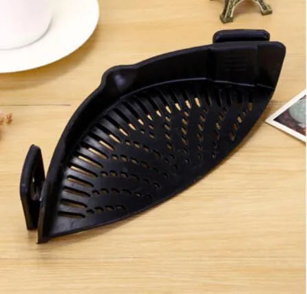 Silicone clip-on kitchen strainer with stainless steel frame attached to pot rim