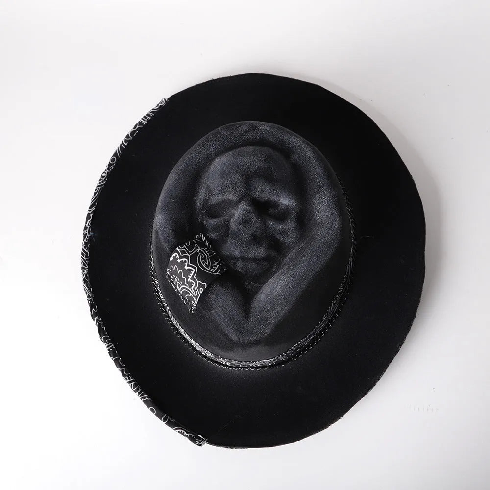 Handmade wool felt skull hat with conical crown design, showing textured surface and distinctive silhouette