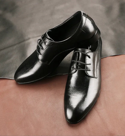 Men's black leather derby shoes with pointed toe, visible sewing details, and antiskid rubber soles