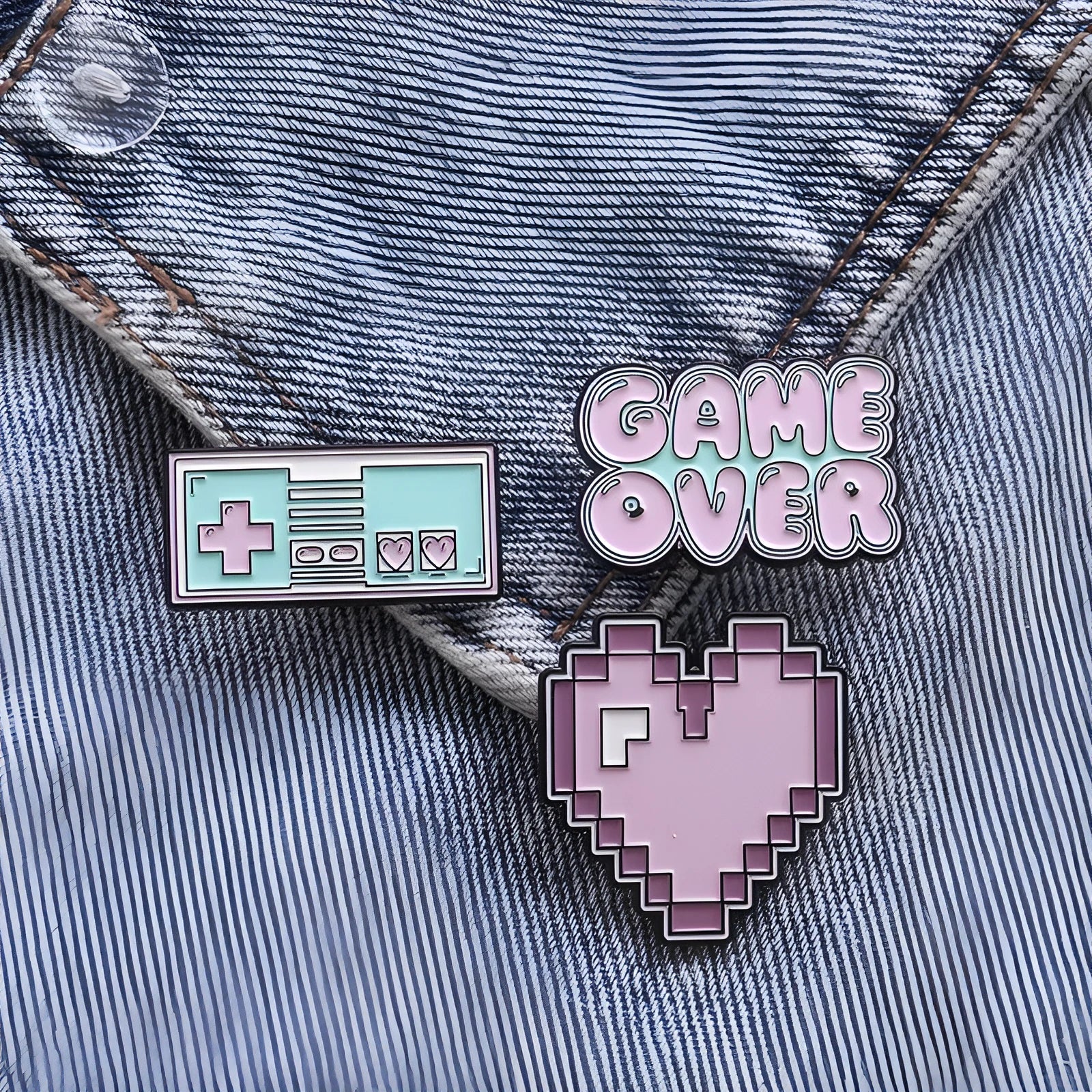 Stereo game console badge made from alloy metal in three colour options for bag mounting.
