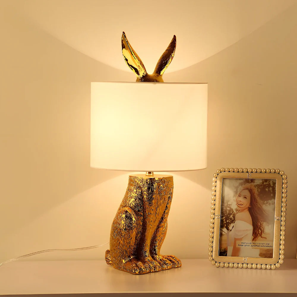 White rabbit table lamp with metal base and resin details, 24cm wide by 49cm high