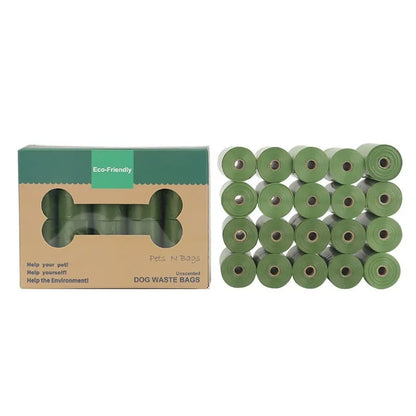 Roll of EPI green degradable pet waste bags next to a transparent dispenser on a grass background.