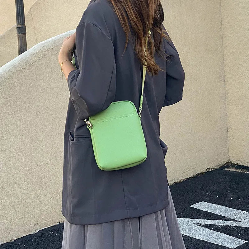 Solid colour mobile phone bag with adjustable strap showing 14.5x5.5x19cm dimensions and PU material construction
