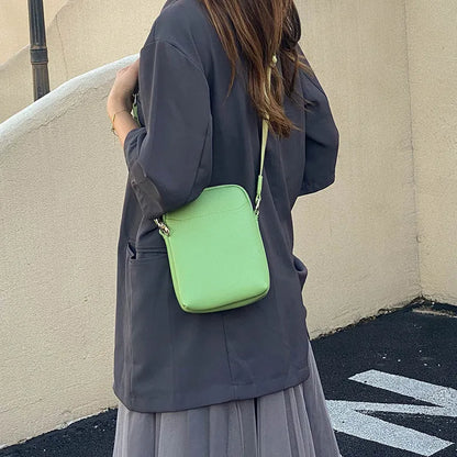 Solid colour mobile phone bag with adjustable strap showing 14.5x5.5x19cm dimensions and PU material construction