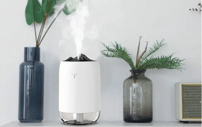 Compact cylindrical USB humidifier with night light in white, pink, or green, showing mist output.