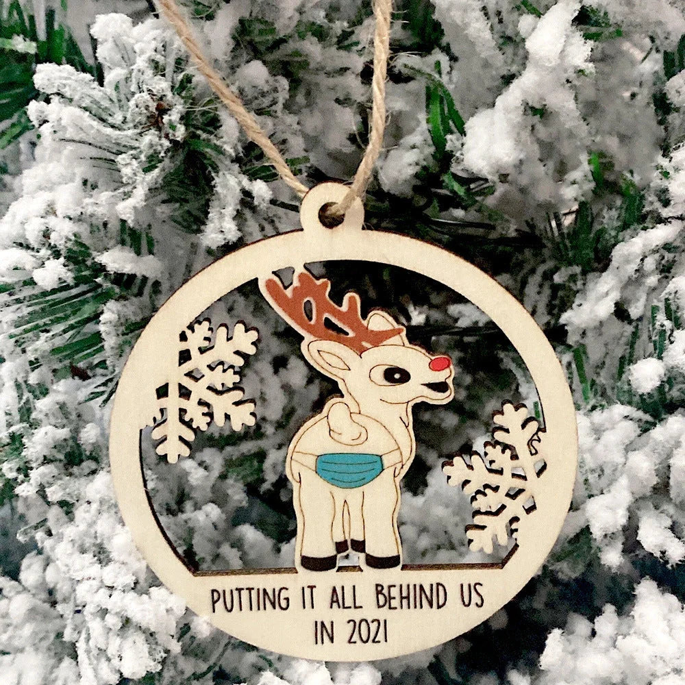 Wooden hollowed-out Christmas ornament with intricate snowman and deer laser-cut design