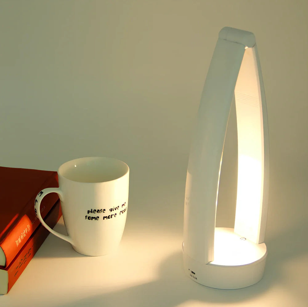 White folding LED desk lamp with touch control on wooden desk