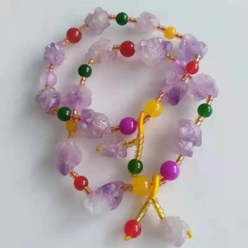 Natural shaped purple amethyst bracelet for women with a fu character bead on a white background.
