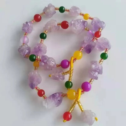 Natural shaped purple amethyst bracelet for women with a fu character bead on a white background.