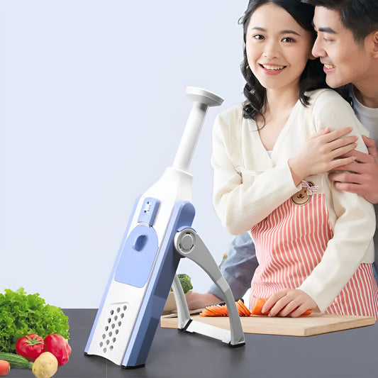 White and blue multifunctional vegetable slicer with stainless steel blades on a kitchen counter.