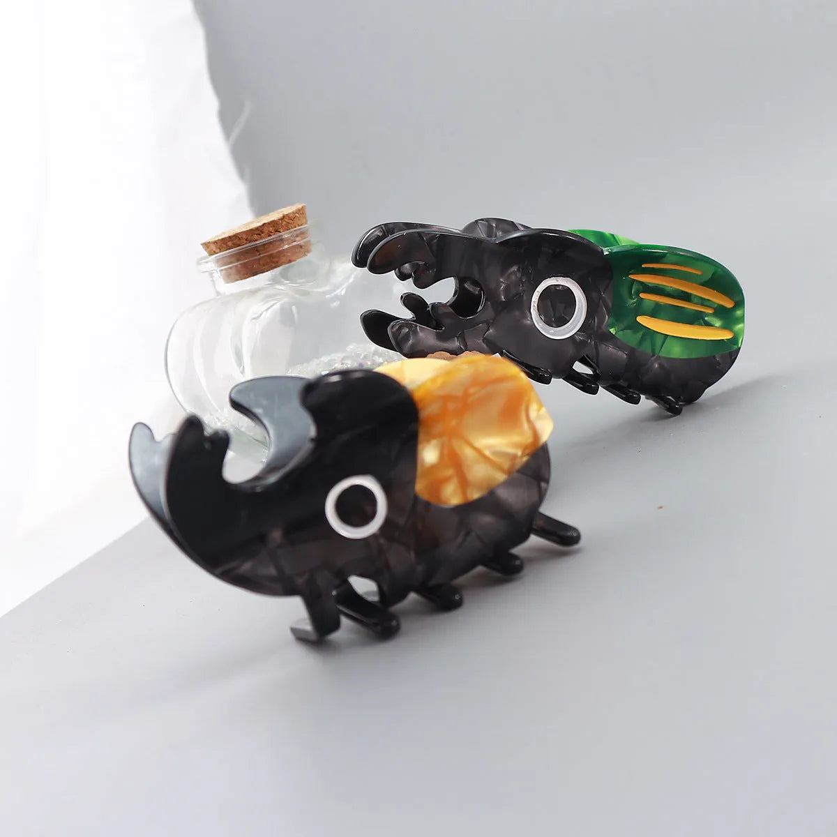 Handmade cartoon insect beetle grip hair clip or brooch in green, orange, or white designs.